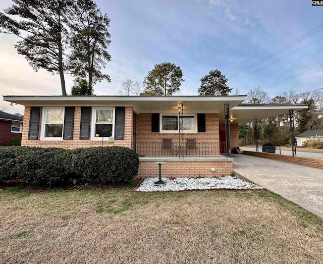 ranch-style home featuring a front yard and a carport