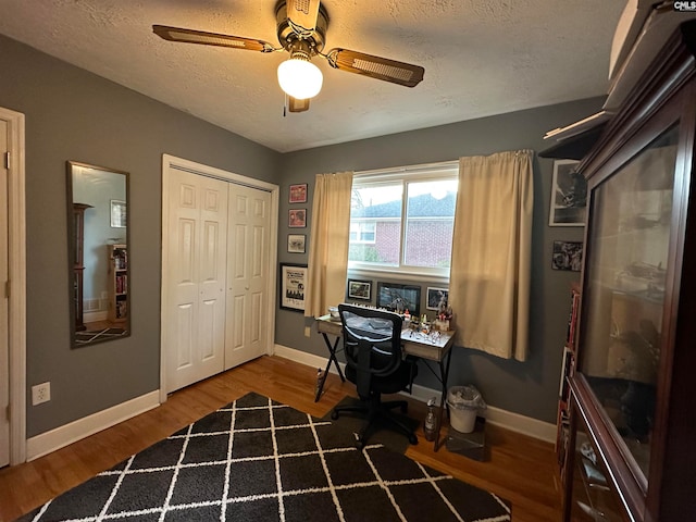 office featuring a textured ceiling, ceiling fan, and wood-type flooring