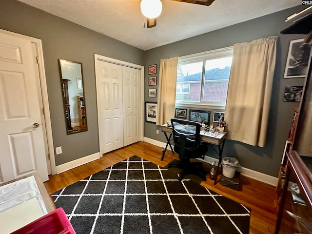 office area with ceiling fan and wood-type flooring