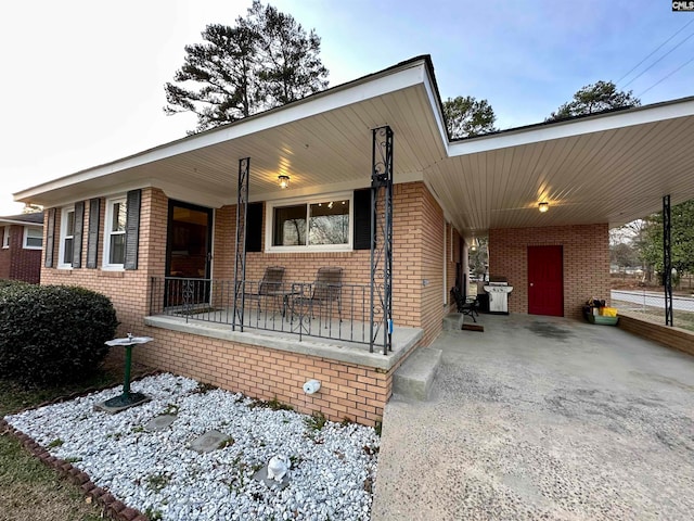 view of front of property featuring covered porch and a carport