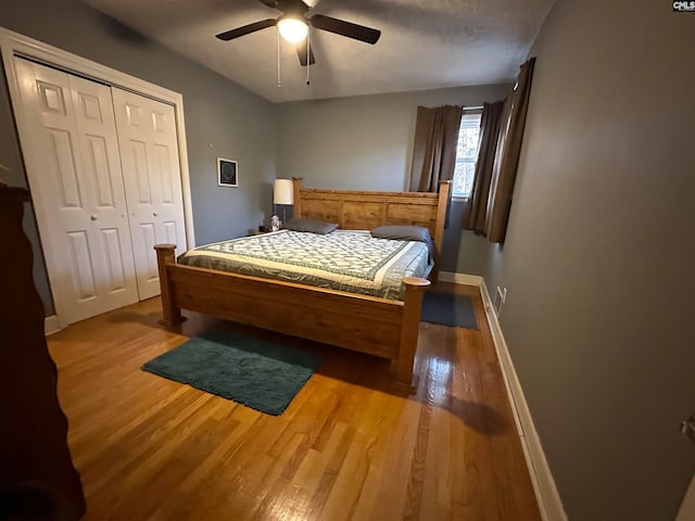 bedroom with ceiling fan, light hardwood / wood-style flooring, and a closet