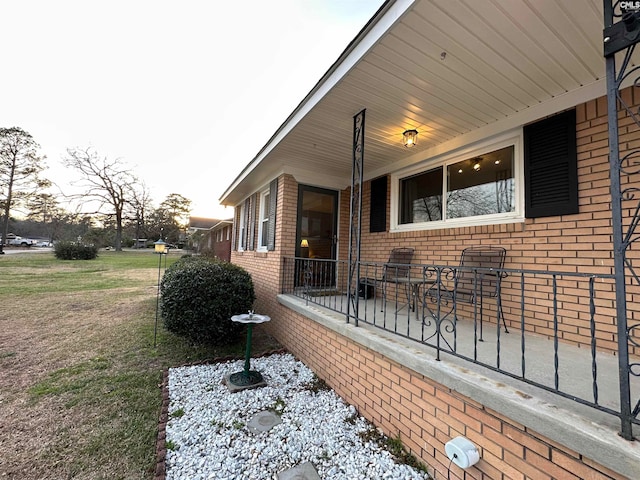 view of side of home with a lawn