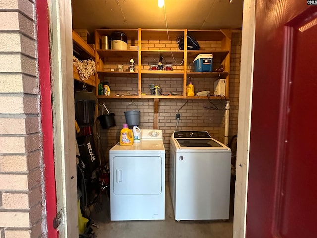 washroom with washing machine and clothes dryer