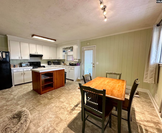 kitchen with light tile flooring, a textured ceiling, black appliances, white cabinets, and track lighting