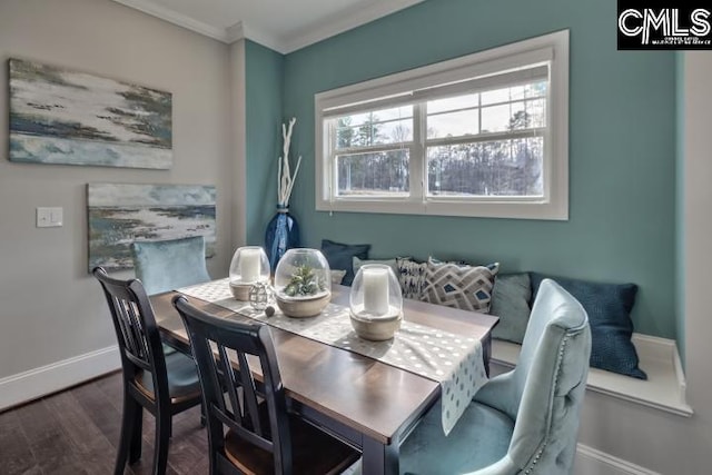 dining area with dark hardwood / wood-style flooring and ornamental molding