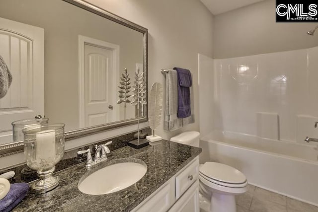 full bathroom with  shower combination, toilet, tile floors, and oversized vanity