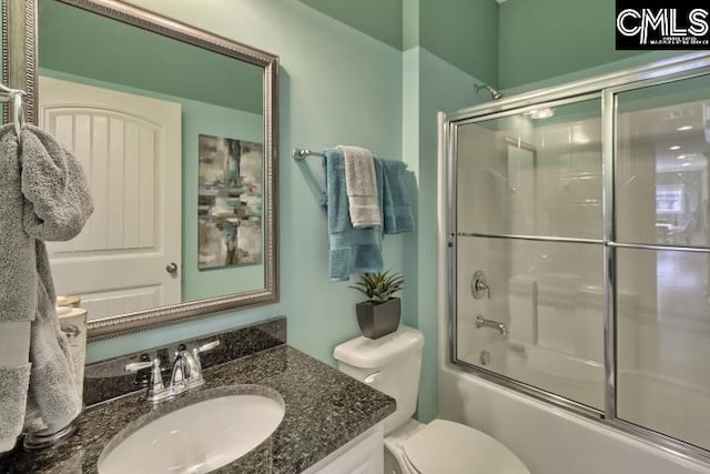 full bathroom featuring toilet, vanity, and combined bath / shower with glass door