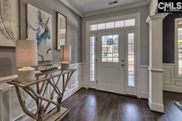 foyer with decorative columns, dark wood-type flooring, and crown molding