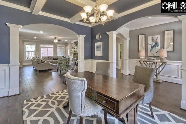 dining room featuring crown molding, decorative columns, and dark hardwood / wood-style flooring