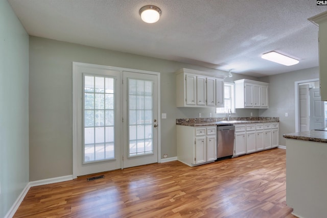 kitchen featuring sink, light hardwood / wood-style flooring, dishwasher, a textured ceiling, and white cabinetry