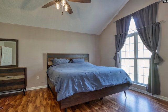 bedroom with dark hardwood / wood-style flooring, ceiling fan, and lofted ceiling