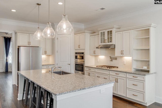 kitchen with light stone countertops, decorative light fixtures, backsplash, sink, and dark hardwood / wood-style flooring