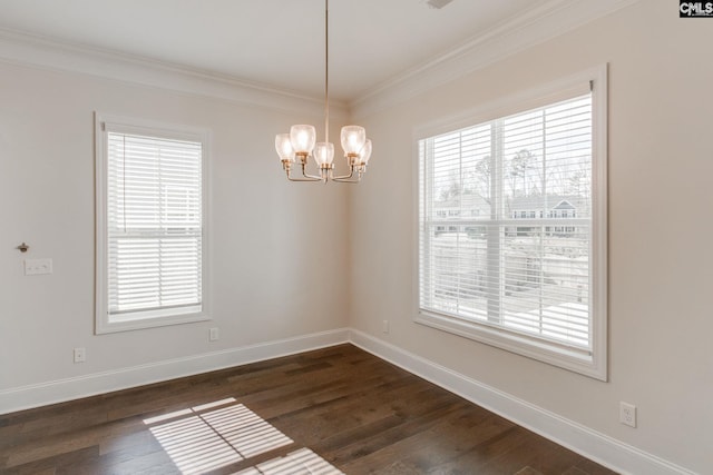 empty room featuring a wealth of natural light and a chandelier