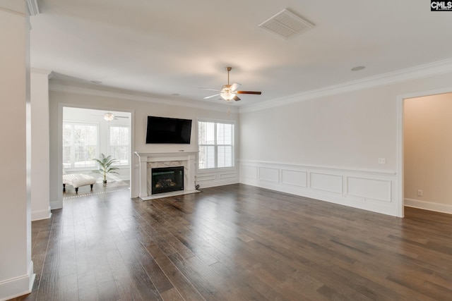 unfurnished living room with a premium fireplace, ceiling fan, dark hardwood / wood-style flooring, and ornamental molding