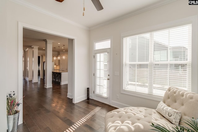 entryway with ceiling fan, decorative columns, dark wood-type flooring, and crown molding