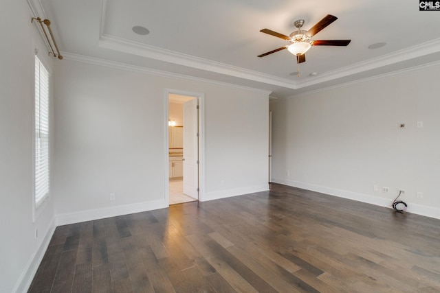 interior space with ceiling fan, ornamental molding, dark hardwood / wood-style floors, and a tray ceiling