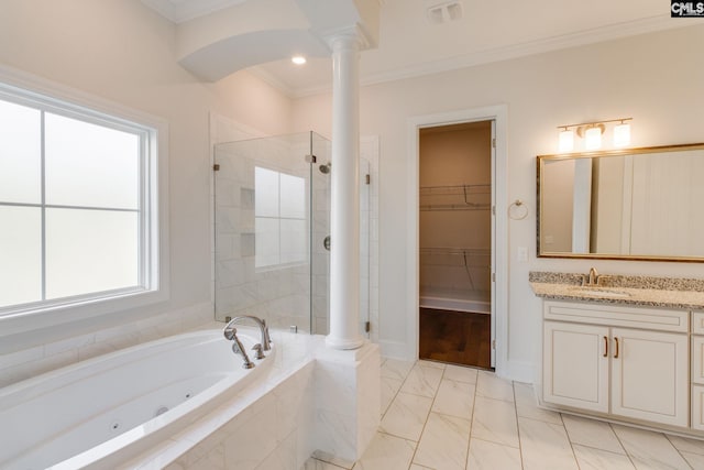 bathroom featuring tile flooring, decorative columns, vanity, shower with separate bathtub, and ornamental molding