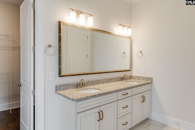 bathroom with tile flooring, dual sinks, and large vanity