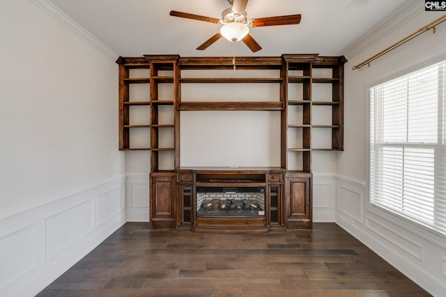 unfurnished living room with ceiling fan, crown molding, dark wood-type flooring, and a fireplace