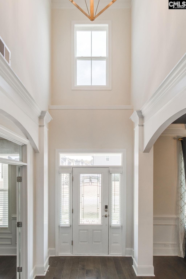 foyer featuring crown molding and dark hardwood / wood-style flooring