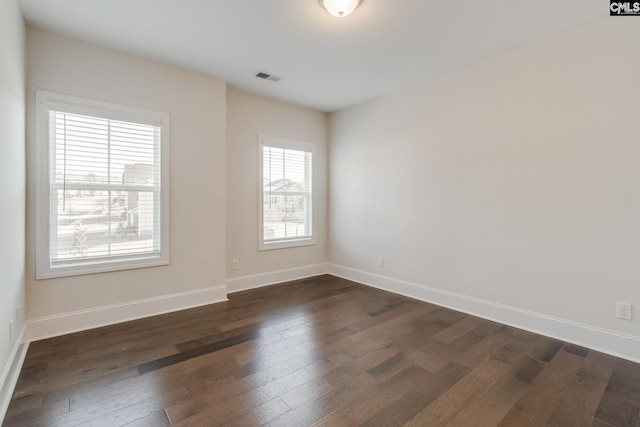 spare room with dark wood-type flooring