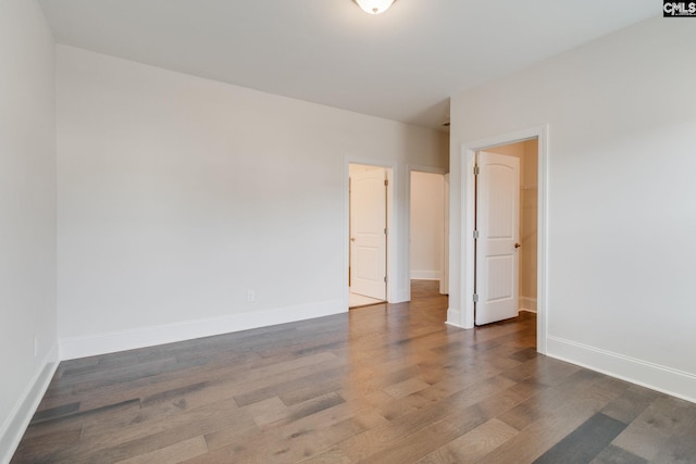 unfurnished room with dark hardwood / wood-style floors