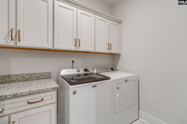 washroom featuring cabinets and independent washer and dryer