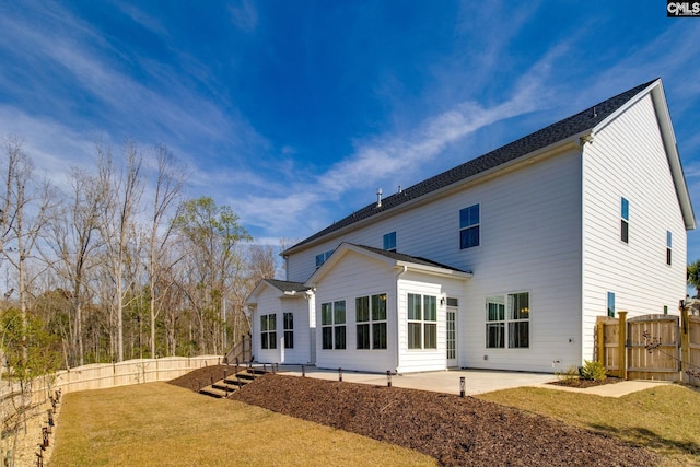 back of property featuring a patio area and a yard