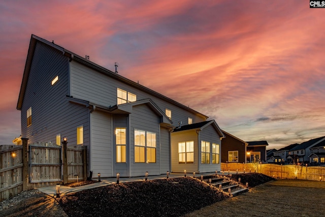 view of back house at dusk