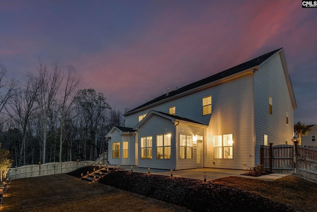 view of back house at dusk