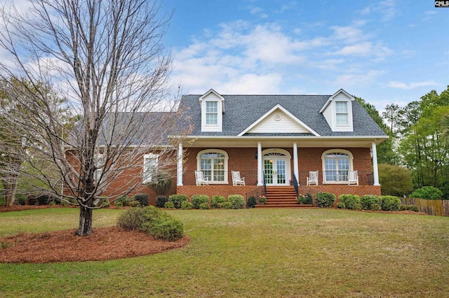 cape cod home with a front yard