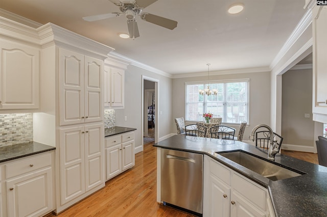 kitchen with tasteful backsplash, crown molding, dishwasher, ceiling fan with notable chandelier, and sink