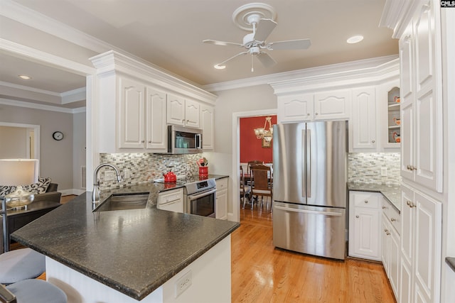 kitchen featuring appliances with stainless steel finishes, tasteful backsplash, and white cabinetry