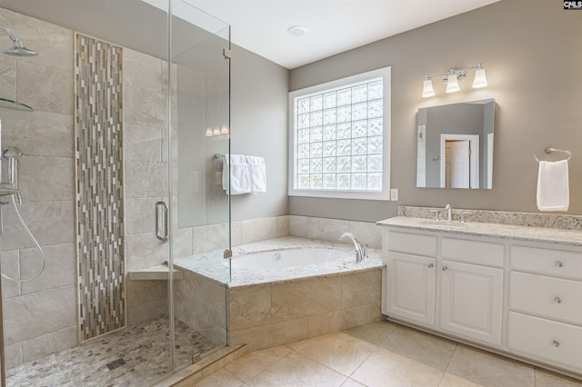 bathroom featuring tile floors, large vanity, and separate shower and tub