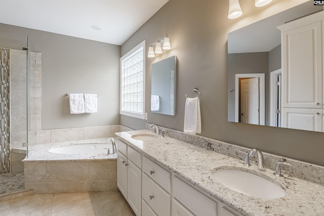 bathroom with tile flooring, independent shower and bath, and double vanity