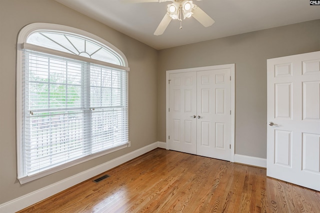 unfurnished bedroom with a closet, ceiling fan, and light hardwood / wood-style flooring