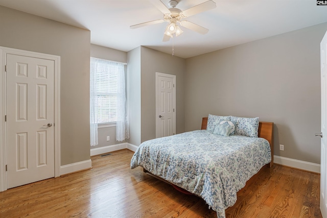 bedroom with ceiling fan and light hardwood / wood-style flooring