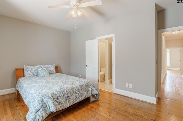 bedroom with ceiling fan, ensuite bath, and light hardwood / wood-style floors