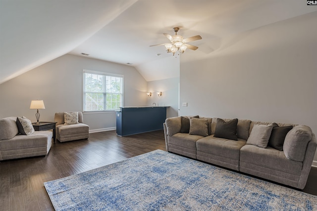 living room featuring ceiling fan, lofted ceiling, and dark wood-type flooring