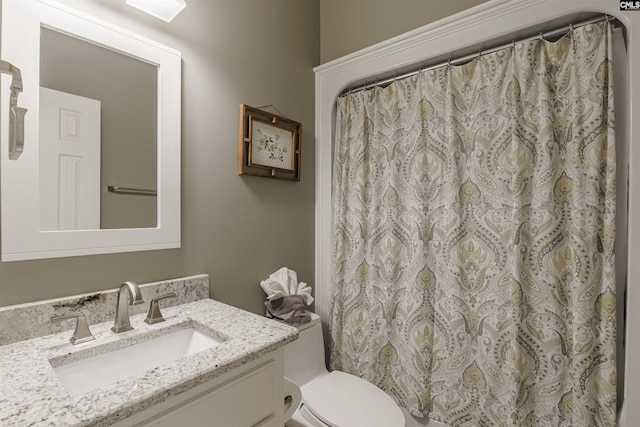 bathroom featuring toilet and vanity