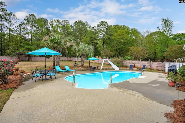 view of swimming pool featuring a patio and a water slide