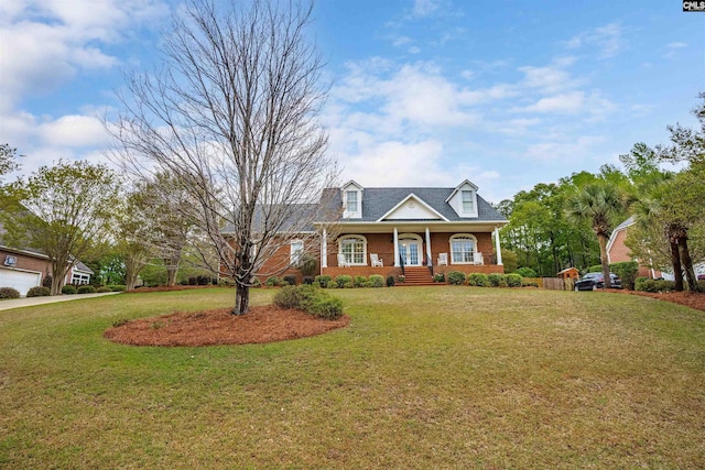 cape cod home with covered porch and a front yard