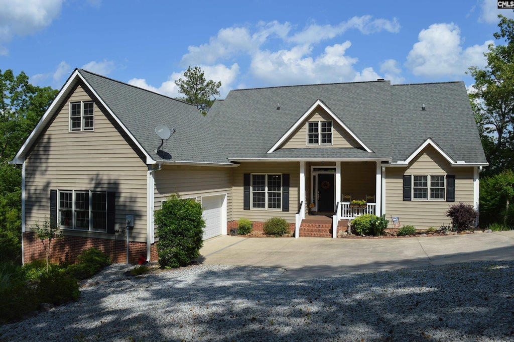 view of front of home featuring covered porch and a garage