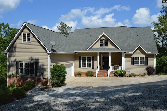 view of front of home featuring covered porch and a garage