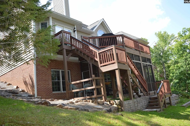 back of house with a lawn and a wooden deck