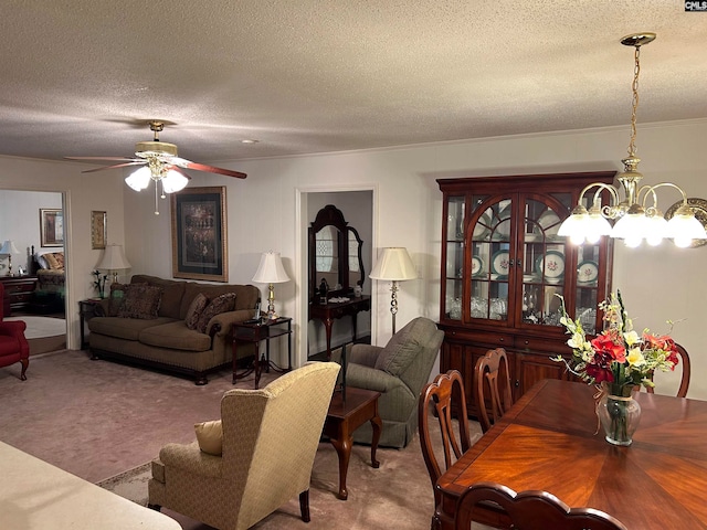 living room featuring carpet floors, a textured ceiling, and ceiling fan with notable chandelier