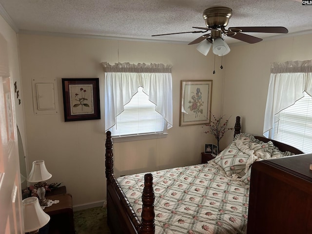 carpeted bedroom with ceiling fan and a textured ceiling