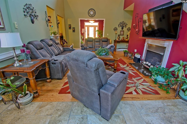 tiled living room with a towering ceiling