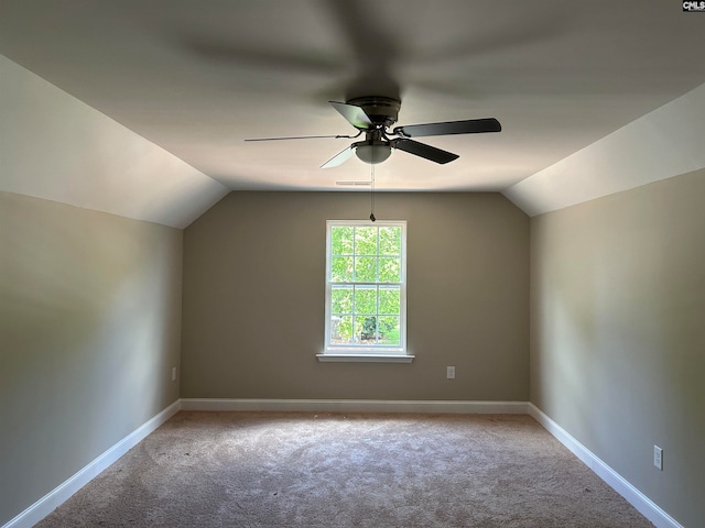 additional living space with light carpet, lofted ceiling, and ceiling fan