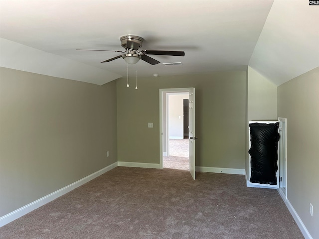 interior space featuring vaulted ceiling, ceiling fan, and carpet flooring